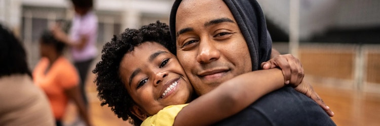 A child and a man hugging