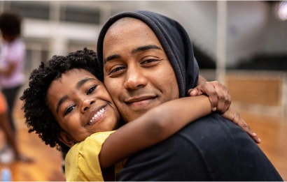 A child and a man hugging