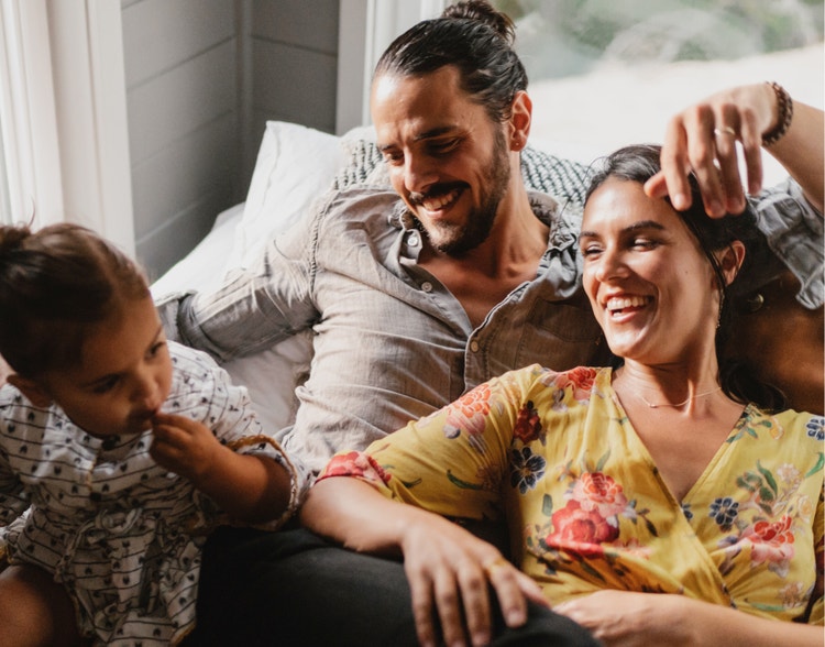 A man, woman, and child sitting together