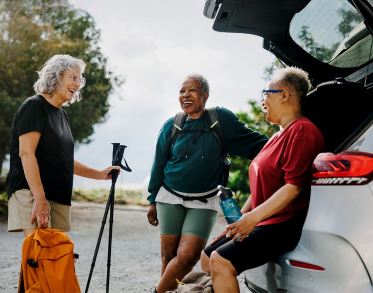 Three women laughing while doing a walking exercise