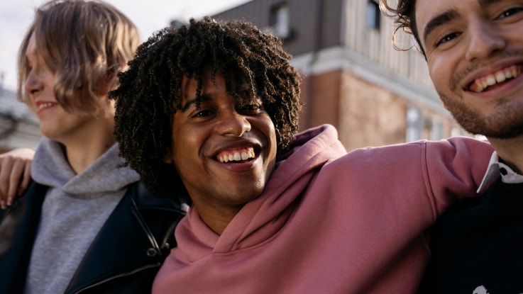 Three young people smiling
