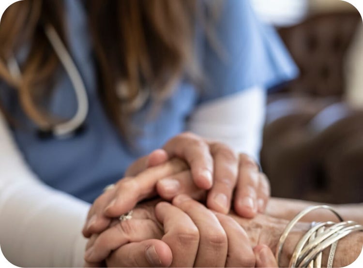 Doctor showing support by holding a patient's hand