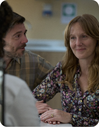 Actor portrayal of a patient and family member speaking with a healthcare professional mobile