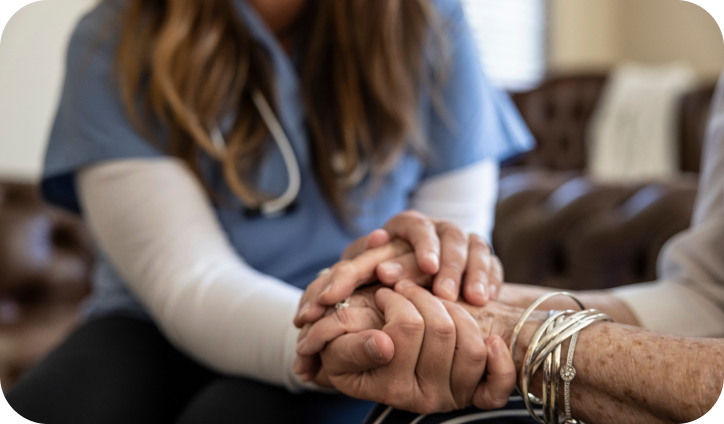 Doctor showing support by holding a patient's hand