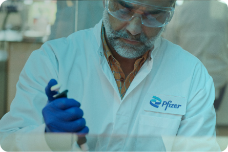 Actor portrayal of a scientist using a pipette in a laboratory