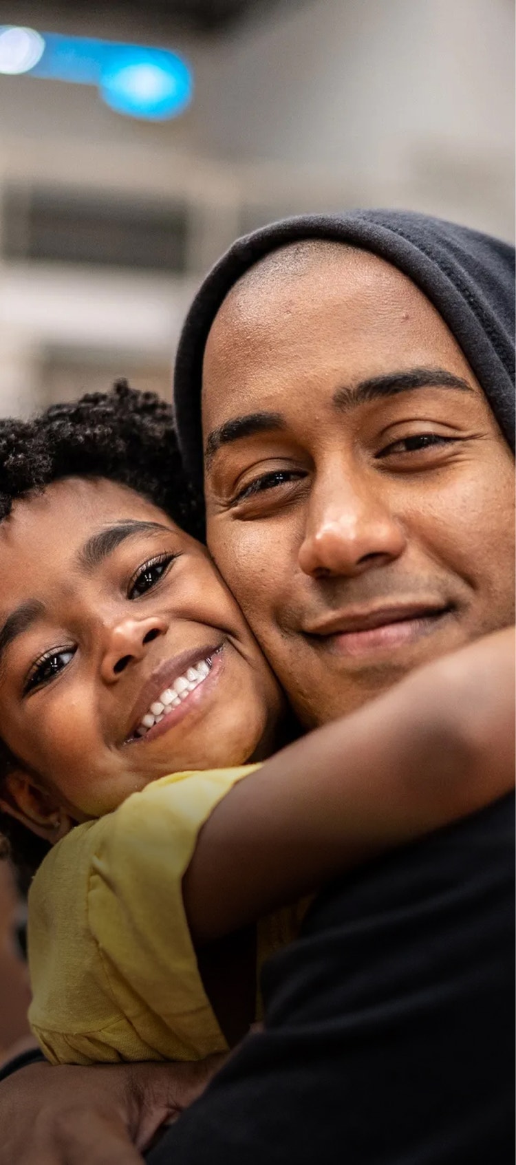 A child and a man hugging