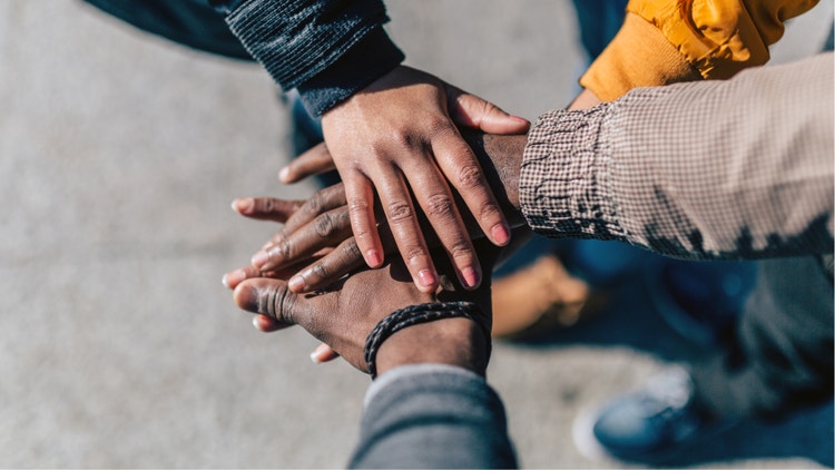 People stacking hands together